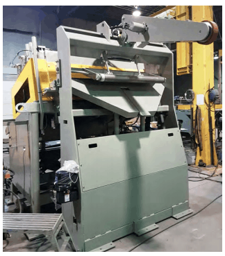 Coil processing equipment by Colt Automation. Seen here: hold down arm, dekinker, chute, peeler/threader, straightener.